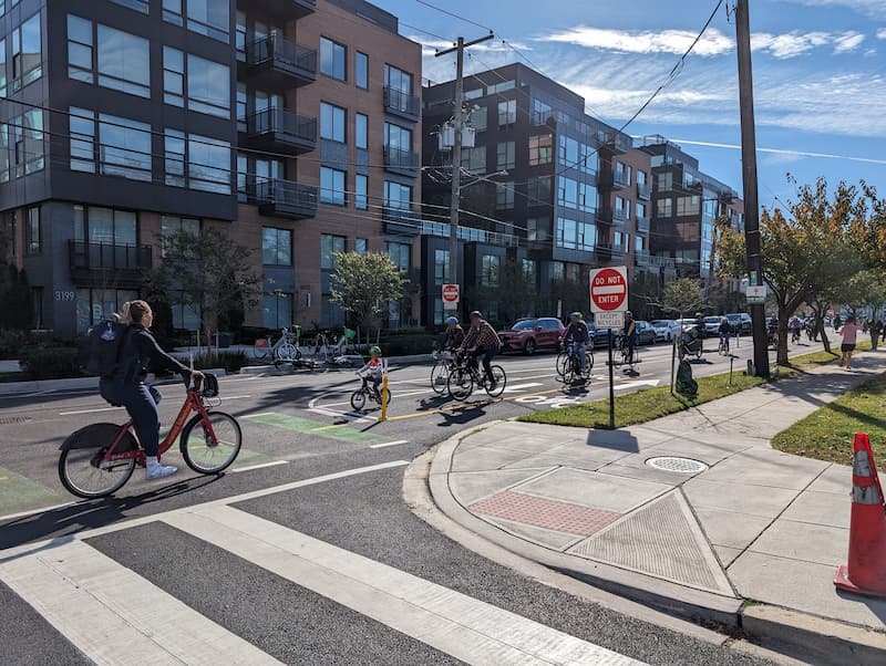 Children and adults biking on 8th Street Northeast